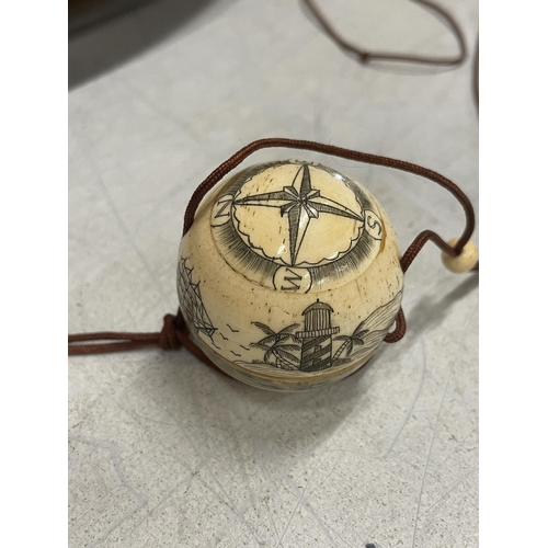 38 - A BONE CARVED COMPASS ON A CORD