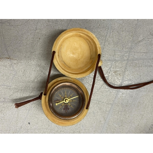 38 - A BONE CARVED COMPASS ON A CORD