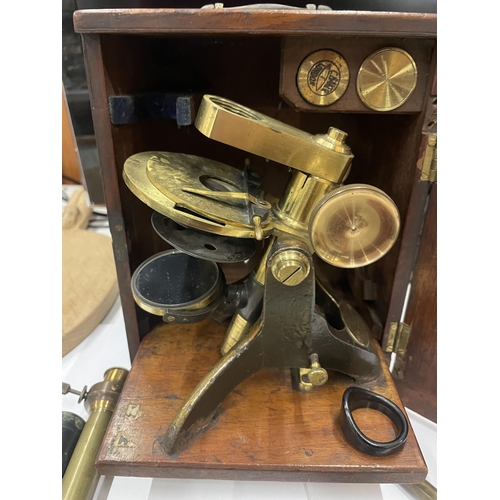 7 - A VINTAGE BRASS MICROSCOPE IN AN OAK BOX WITH A DRAWER OF SLIDES AND TWO FURTHER FITMENTS