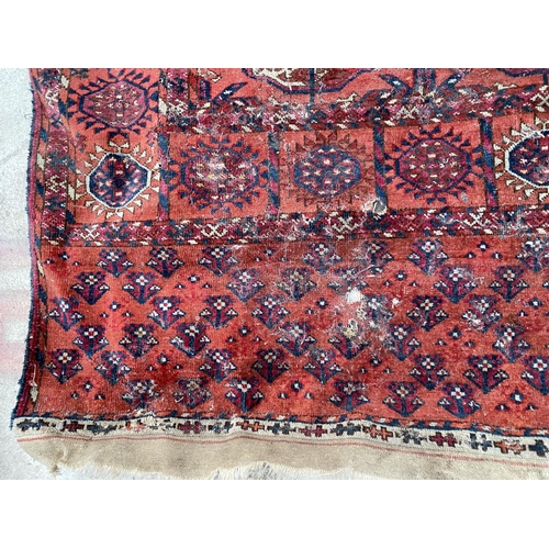 2481 - A VINTAGE RED PATTERNED FRINGED RUG