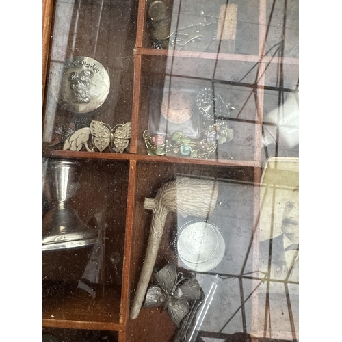 2041 - A VINTAGE GLASS FRONTED DISPLAY CABINET WITH AN ASSORTMENT OF  ITEMS TO INCLUDE A PIPE AND CHRISTENI... 