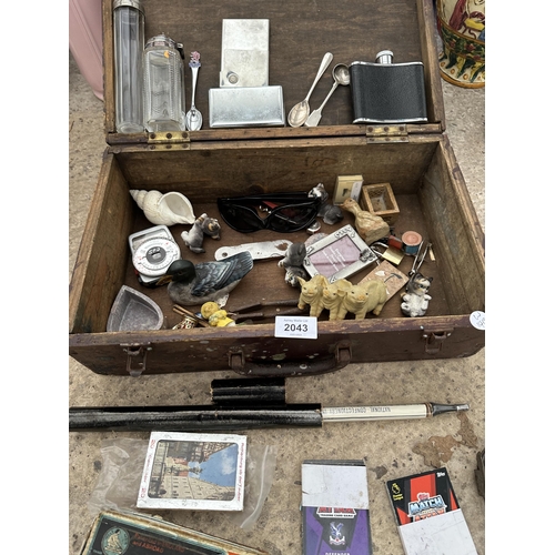 2043 - A VINTAGE WOODEN BOX CONTAINING AN ASSORTMENT OF ITEMS TO INCLUDE TEASPOONS, FIGURES AND TOYS ETC