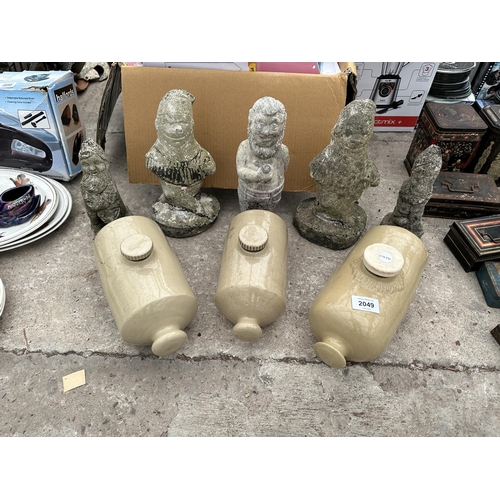 2049 - FOUR CONCRETE GARDEN GNOMES AND THREE STONEWARE HOT WATER BOTTLES