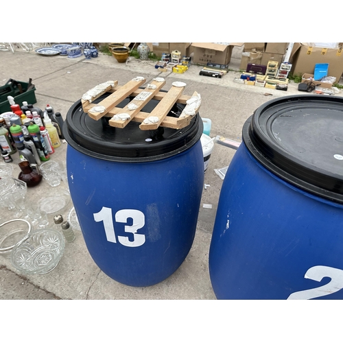 2052 - THREE LIDDED PLASTIC DRUMS TWO WITH TROLLEY BASES