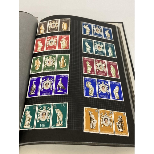 395 - AN ALBUM CONTAINING BLOCKS OF STAMPS TO INCLUDE COMMEMORATIVE, ETC.,