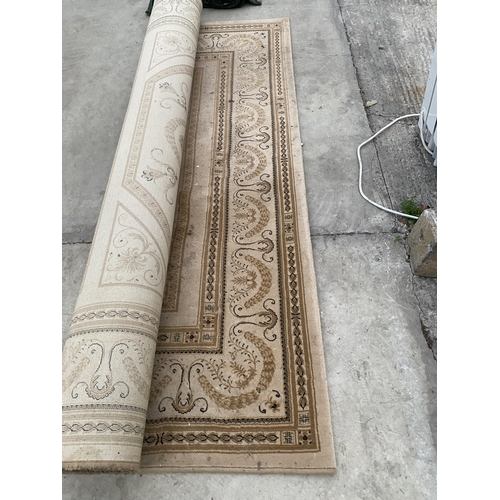 2480A - A LARGE CREAM PATTERNED RUG