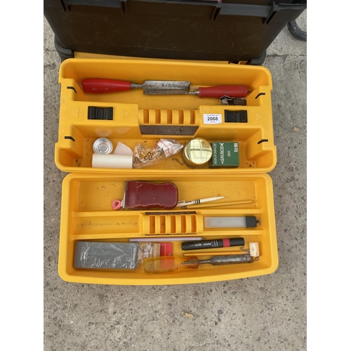 2068 - A PLASTIC STACKING TOOL BOX WITH AN ASSORTMENT OF TOOLS TO INCLUDE CHISELS ETC