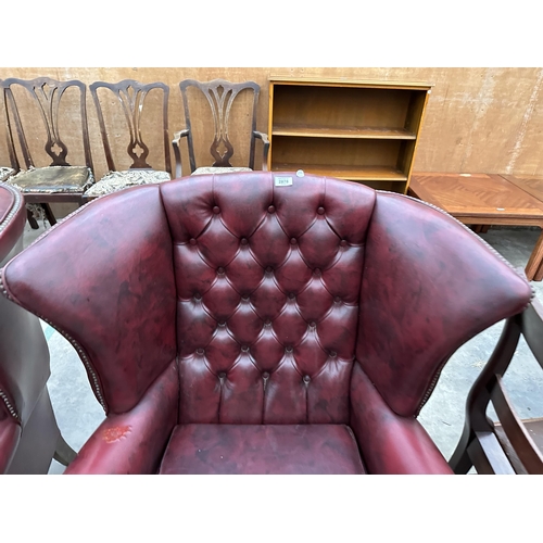 2878 - A PAIR OF MODERN BUTTON-BACK WINGED OXBLOOD FIRESIDE CHAIRS