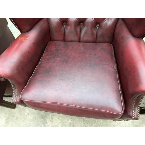 2878 - A PAIR OF MODERN BUTTON-BACK WINGED OXBLOOD FIRESIDE CHAIRS