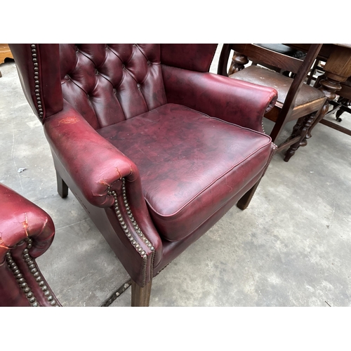 2878 - A PAIR OF MODERN BUTTON-BACK WINGED OXBLOOD FIRESIDE CHAIRS