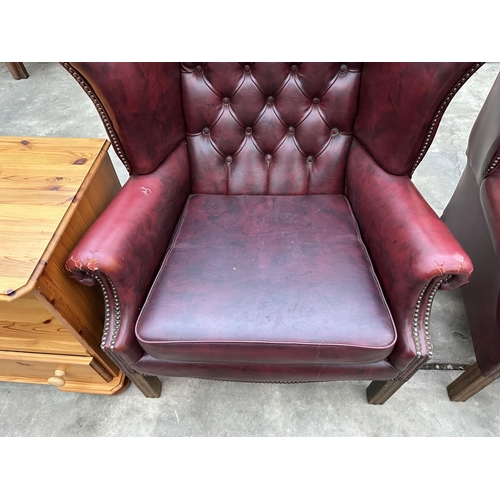 2878 - A PAIR OF MODERN BUTTON-BACK WINGED OXBLOOD FIRESIDE CHAIRS