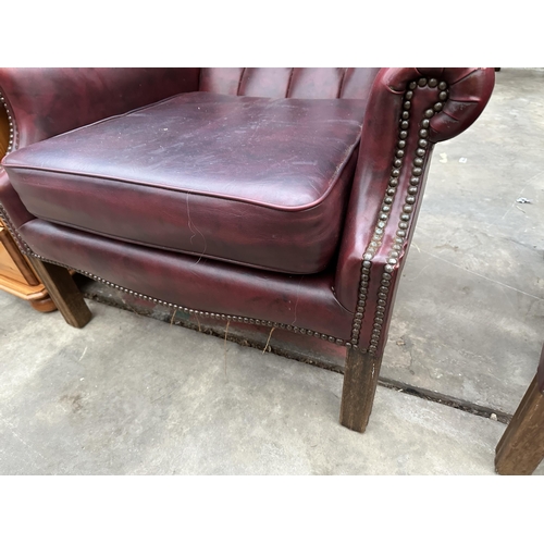 2878 - A PAIR OF MODERN BUTTON-BACK WINGED OXBLOOD FIRESIDE CHAIRS