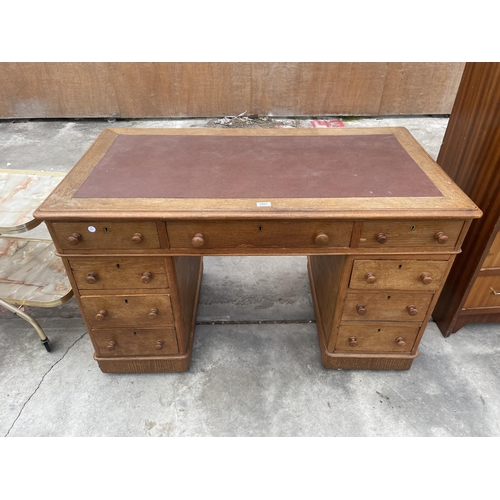 2887 - A VICTORIAN OAK TWIN PEDESTAL DESK ENCLOSING NINE DRAWERS, 47 X 25