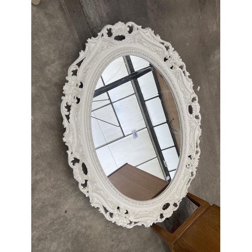 2890 - A WHITE PAINTED OVAL VICTORIAN STYLE WALL MIRRORM WITH FOLIATE DECORATION, 36 X 28