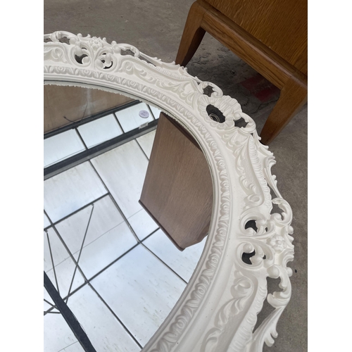 2890 - A WHITE PAINTED OVAL VICTORIAN STYLE WALL MIRRORM WITH FOLIATE DECORATION, 36 X 28