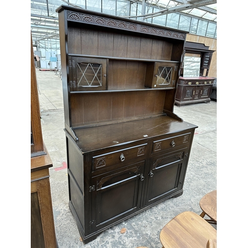 2903 - A REPRODUCTION DRESSER WITH PLATE RACK ENCLOSING TWO GLAZED AND LEADED DOORS, 49