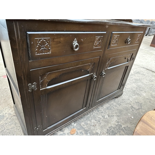 2903 - A REPRODUCTION DRESSER WITH PLATE RACK ENCLOSING TWO GLAZED AND LEADED DOORS, 49