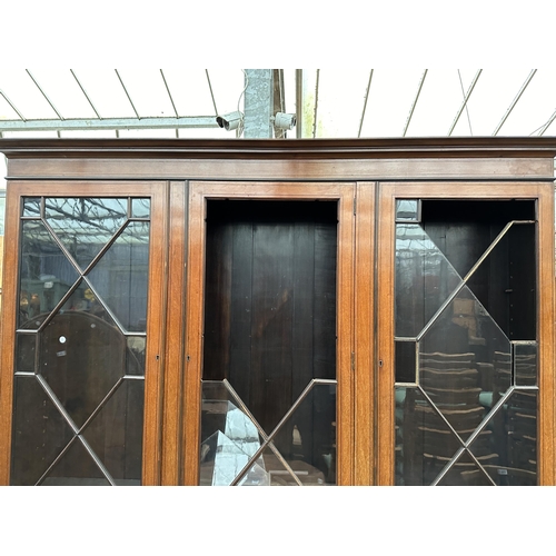 2904 - AN EDWARDIAN MAHOGANY AND INLAID BREAKFRONT TWO DOOR BOOKCASE ON BASE, 74