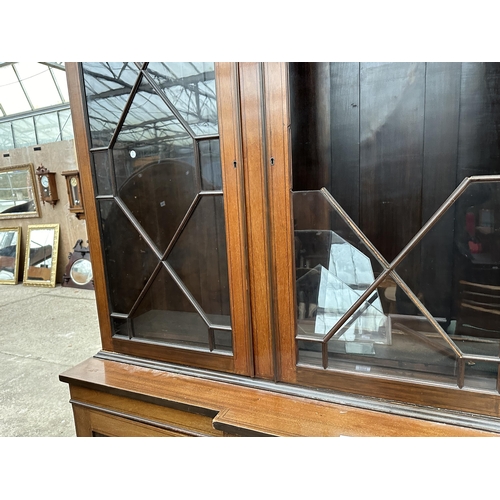 2904 - AN EDWARDIAN MAHOGANY AND INLAID BREAKFRONT TWO DOOR BOOKCASE ON BASE, 74