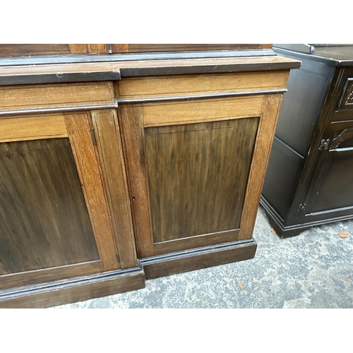 2904 - AN EDWARDIAN MAHOGANY AND INLAID BREAKFRONT TWO DOOR BOOKCASE ON BASE, 74