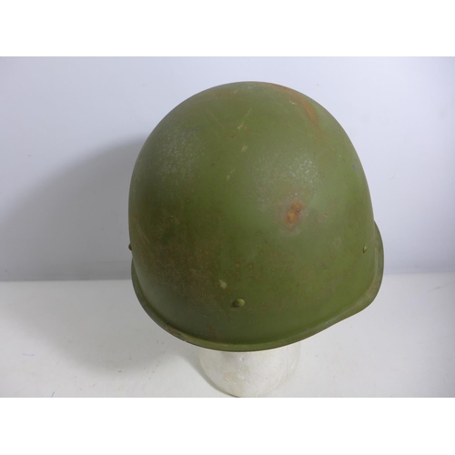 302 - A GREEN PAINTED METAL MILITARY HELMET AND LINING