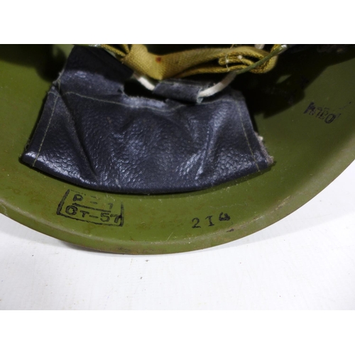 302 - A GREEN PAINTED METAL MILITARY HELMET AND LINING