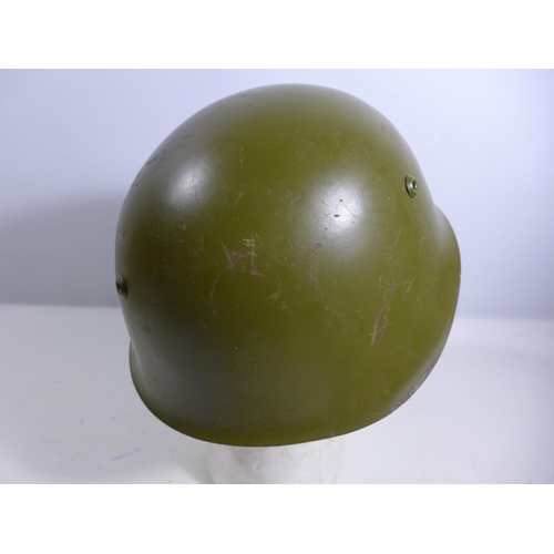 303 - A GREEN PAINTED METAL MILITARY HELMET AND LINING