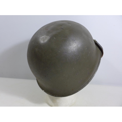 305 - A GREEN PAINTED METAL MILITARY HELMET AND LINING