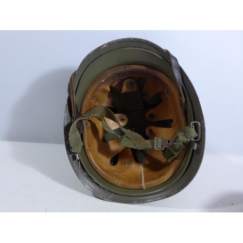 305 - A GREEN PAINTED METAL MILITARY HELMET AND LINING