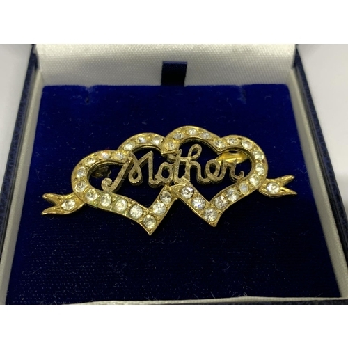 44 - A SILVER AND GOLD MOTHER BROOCH