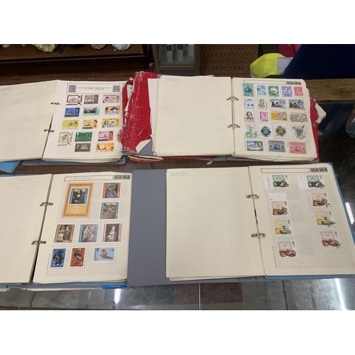 494 - FOUR STAMP ALBUMS CONTAINING WORLD STAMPS