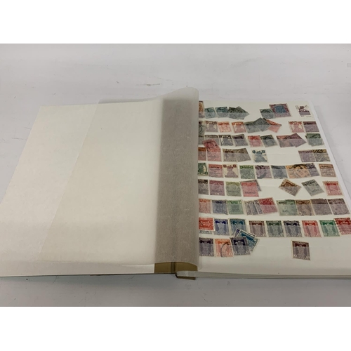 497A - A STAMP ALBUM CONTAINING STAMPS OF INDIA, PAKISTAN AND BANGLADESH