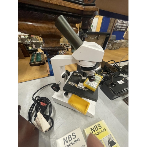 31 - A MODERN ELECTRIC MICROSCOPE WITH SLIDES SEEN WORKING BUT NO WARRANTY