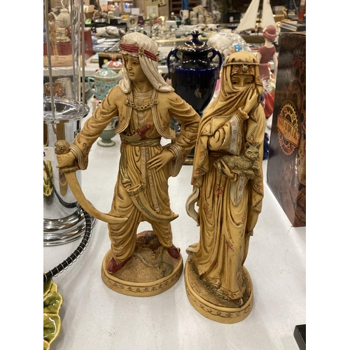 159 - TWO VERY HEAVY SHEIKH AND ARAB LADY FIGURES, HEIGHT 31CM