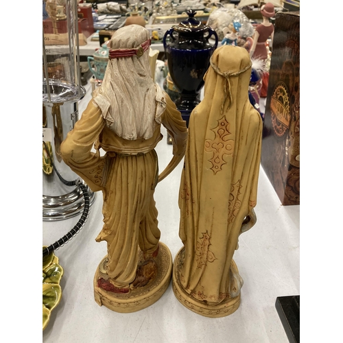 159 - TWO VERY HEAVY SHEIKH AND ARAB LADY FIGURES, HEIGHT 31CM