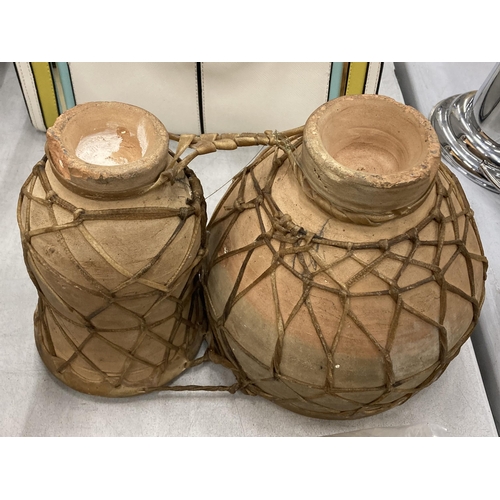 165 - A SET OF TWO ANIMAL HIDE AFRICAN DRUMS