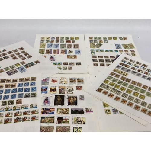 383 - TEN PLUS SHEETS CONTAINING STAMPS FROM UGANDA