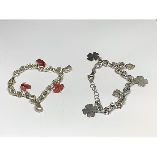 567A - TWO SILVER CHARM BRACELETS