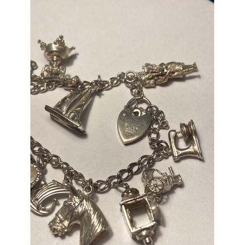 584A - A SILVER CHARM BRACELET WITH FOURTEEN CHARMS