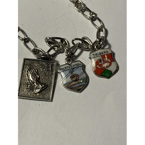 672 - A SILVER BRACELET WITH SIX CHARMS