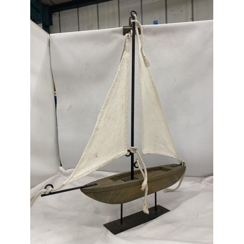 829 - A VINTAGE WOODEN SAILING BOAT ON A DISPLAY PLINT, HEIGHT 56CM, LENGTH 46CM