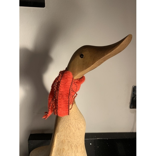 1055 - A LARGE WOODEN DUCK FIGURE WITH A RED SCARF