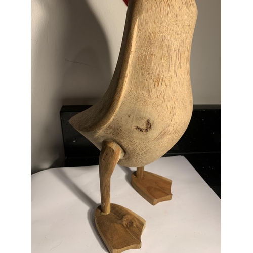 1055 - A LARGE WOODEN DUCK FIGURE WITH A RED SCARF