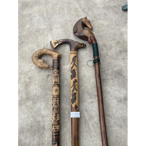 1525A - THREE VARIOUS DECORATIVE WOODEN WALKING STICKS TO INCLUDE A HORSE THUMB STICK, AN EAGLE HEAD WALKING... 