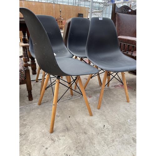 2540 - A SET OF FOUR MOULDED PLASTIC DINING CHAIRS ON KICK-OUT LEGS