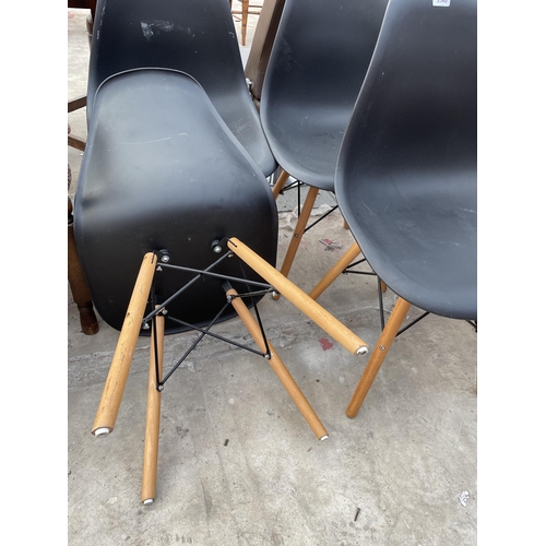 2540 - A SET OF FOUR MOULDED PLASTIC DINING CHAIRS ON KICK-OUT LEGS