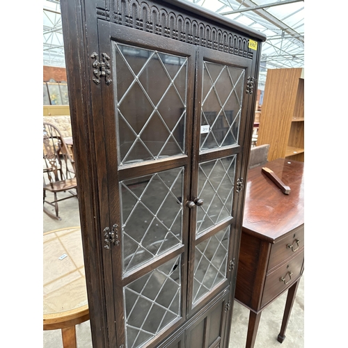 2810 - AN OAK CORNER CUPBOARD WITH GLAZED AND LEADED UPPER PORTION