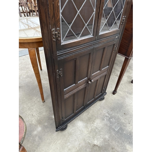 2810 - AN OAK CORNER CUPBOARD WITH GLAZED AND LEADED UPPER PORTION