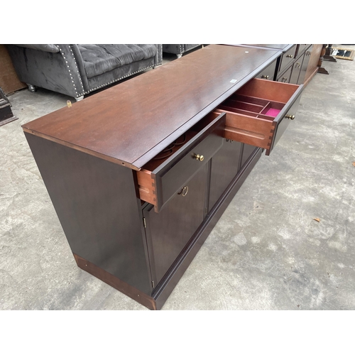 2902 - A STAG MINSTREL SIDEBOARD ENCLOSING THREE DRAWERS AND THREE CUPBOARDS, 54