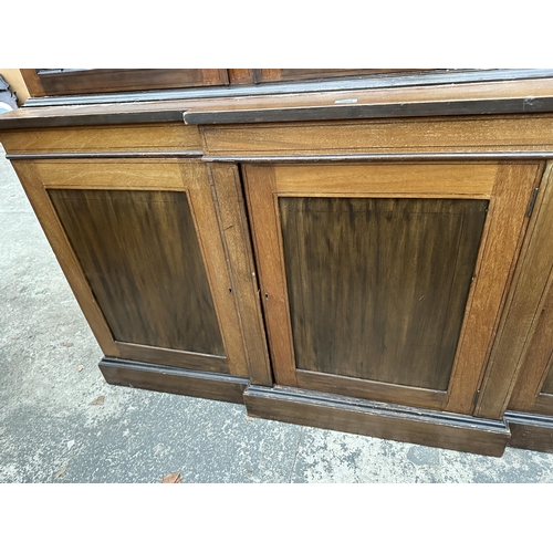 2904 - AN EDWARDIAN MAHOGANY AND INLAID BREAKFRONT TWO DOOR BOOKCASE ON BASE, 74